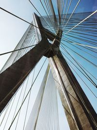 Low angle view of suspension bridge against sky