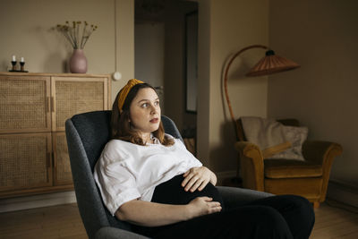 Pregnant woman resting in chair