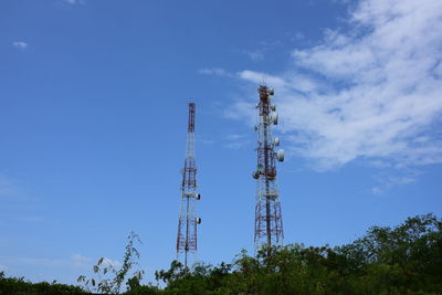 Low angle view of communications tower against blue sky