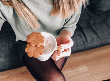 Midsection of woman holding ice cream