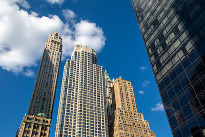 Low angle view of modern buildings against blue sky