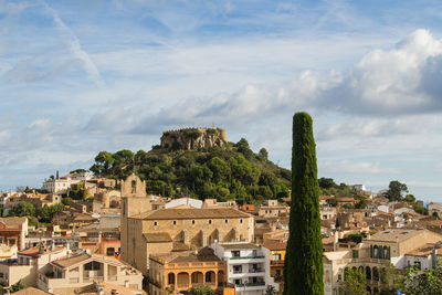 View of townscape against cloudy sky