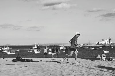 People on beach against sky