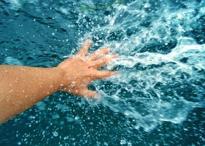 Low section of woman swimming in sea