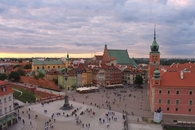 High angle view of buildings in town against cloudy sky