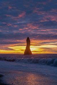 Scenic view of sea against sky during sunset at reynisdrangar, iceland