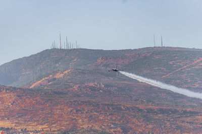 Scenic view of land and mountains against clear sky