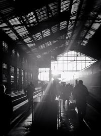 Silhouette people walking at railroad station