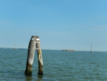 Sailboat in sea against clear sky