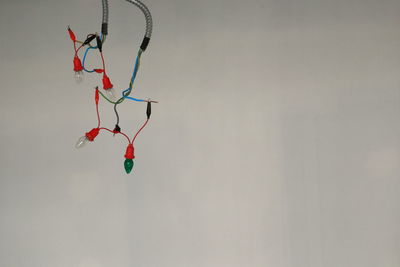 Low angle view of red decoration hanging against wall