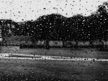 Full frame shot of wet glass window in rainy season