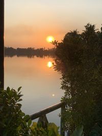 Scenic view of lake against sky during sunset