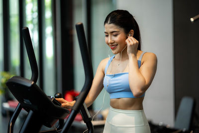 Young woman standing in gym