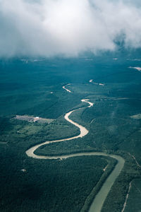 Top view scenery showing natural river, green forest and mountain in sabah. 