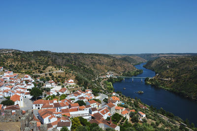 High angle view of buildings against clear blue sky