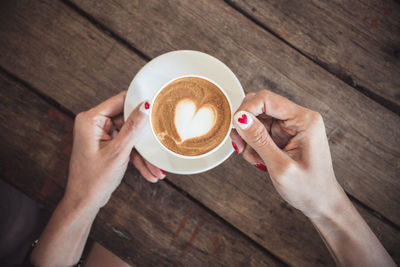 High angle view of woman holding coffee cup