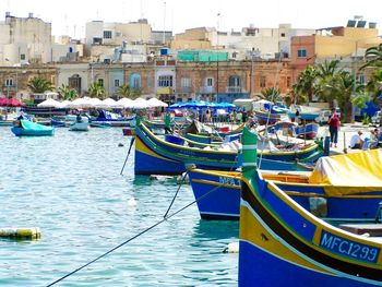 Boats in canal with buildings in background