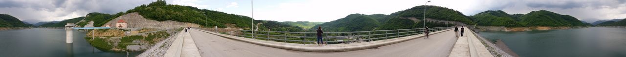 Panoramic view of dam and mountains against sky