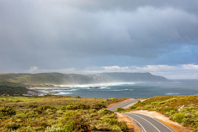 Road by sea against sky