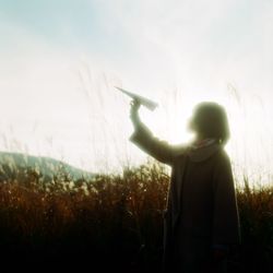 Woman standing on grassy field