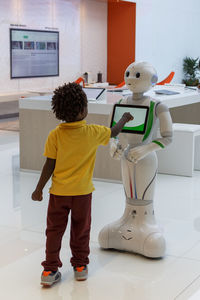 Rear view of boy statue against wall