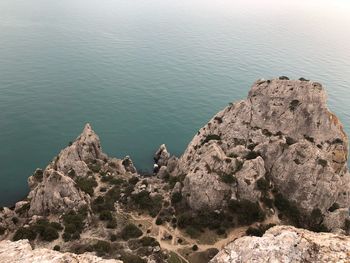 High angle view of rocks on sea shore against sky