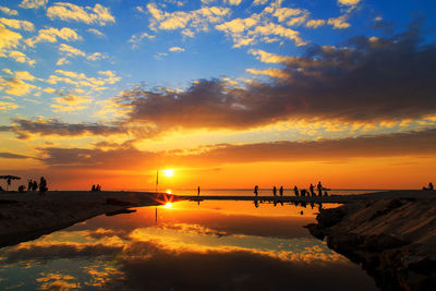 Scenic view of sea against orange sky