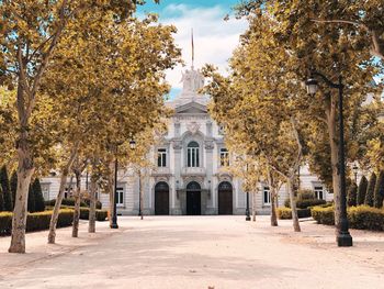 Trees and historic building against sky