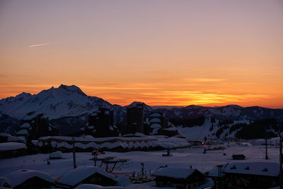 Scenic view of snowcapped mountains against sky during sunset