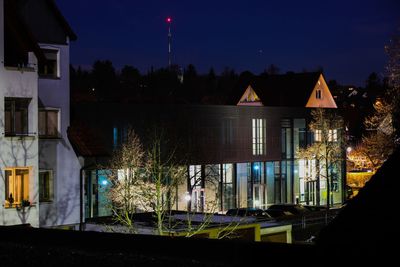 Illuminated buildings against sky at night