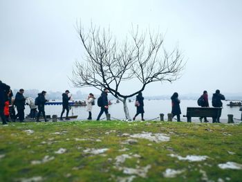 People on land by lake