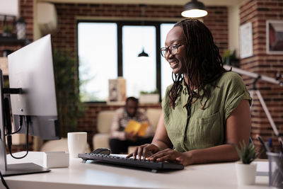 Young woman using laptop at table