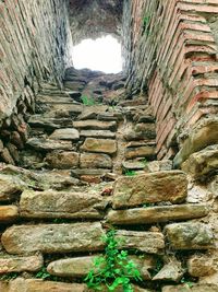 Low angle view of old stone wall