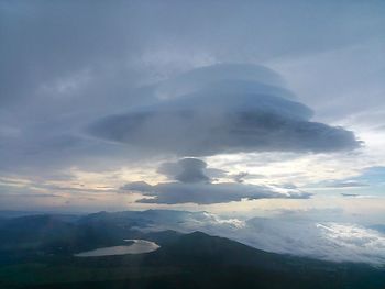 Scenic view of mountains against cloudy sky