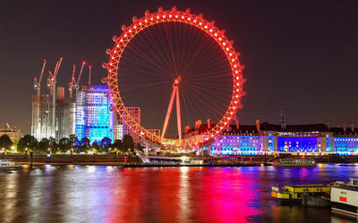 Illuminated ferris wheel at night