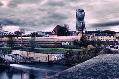 View of cityscape against cloudy sky