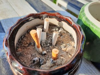 High angle view of cigarette in container on table