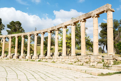 View of columns against cloudy sky