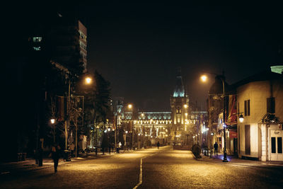 Illuminated city street at night