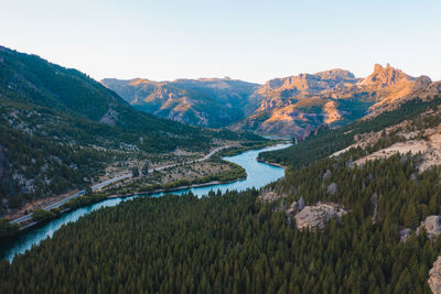 Scenic view of river and mountains against clear sky