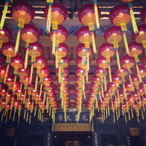 Low angle view of illuminated lanterns hanging on ceiling