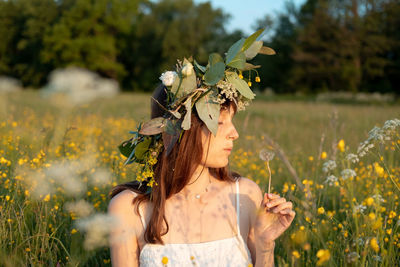 Portrait of woman holding flowers