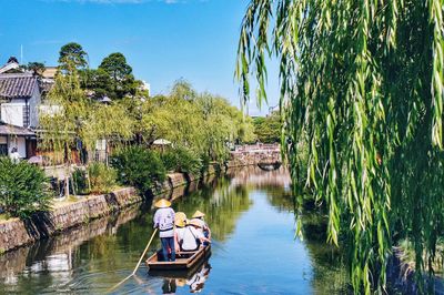 People on japanese gondola in canal