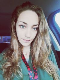 Portrait of beautiful young woman in car