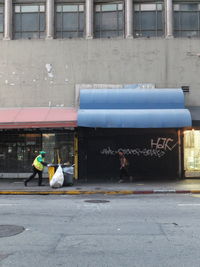 People working on street by building