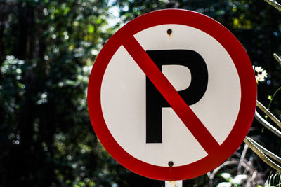 Close-up of road sign against sky