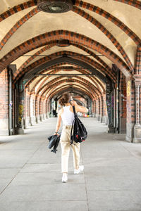 Rear view of women walking in corridor of building