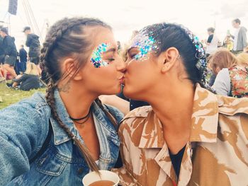 Lesbian couple kissing in park