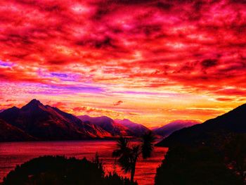 Scenic view of dramatic sky over silhouette landscape