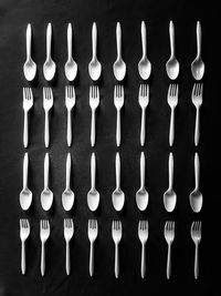 Directly above shot of plastic spoons at forks arranged on table